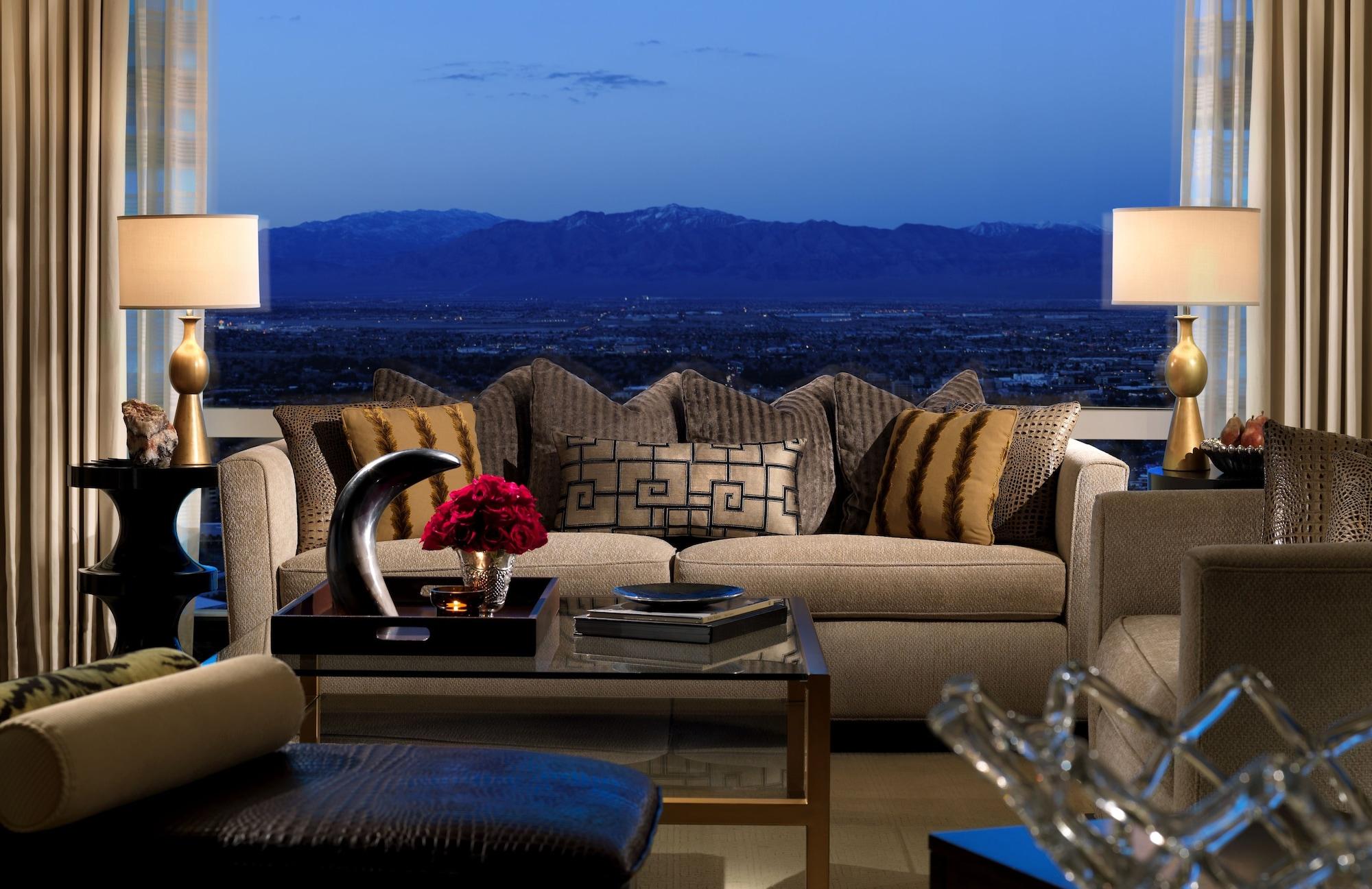 Trump International Hotel Лас Вегас Екстериор снимка The photo depicts a stylish and elegant living room with a sophisticated design. In the foreground, there's a plush sofa adorned with various patterned cushions, including decorative pillows with geometric designs and stripes. There are two bedside l