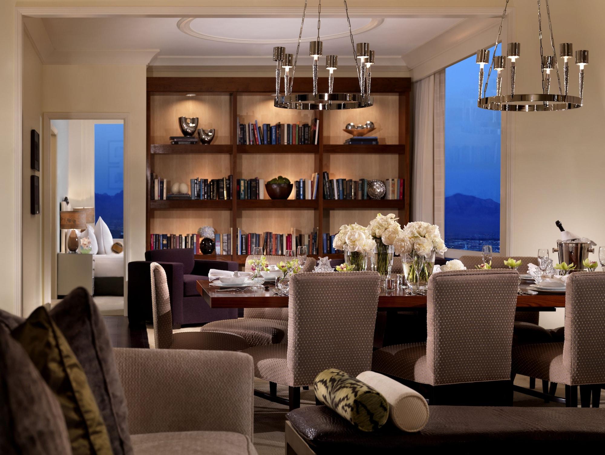 Trump International Hotel Лас Вегас Екстериор снимка The photo depicts a beautifully designed interior space, likely a modern dining room or lounge area. In the foreground, there are plush chairs and a sofa, creating a cozy atmosphere. The dining table in the middle is set for a meal, adorned with flow